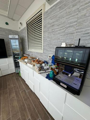 a kitchen with a counter with a television on it at Vista Mare in Mola di Bari