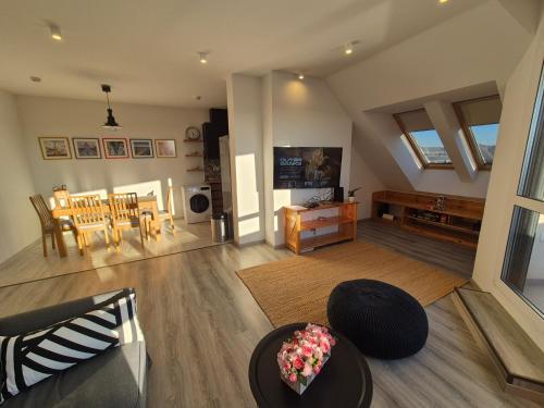 a living room with a couch and a table at Jókai Corner Apartment in Debrecen