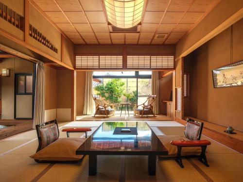 a living room with a table and chairs at Sekitaitei Ishida in Achi