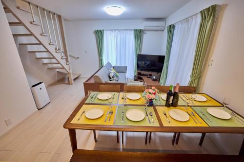 a living room with a table with plates on it at APROStay富士河口湖小立9 in Fujikawaguchiko