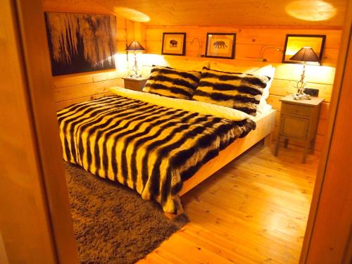 a bedroom with a bed with a zebra blanket at Chalet Sonnberg in Niedernsill