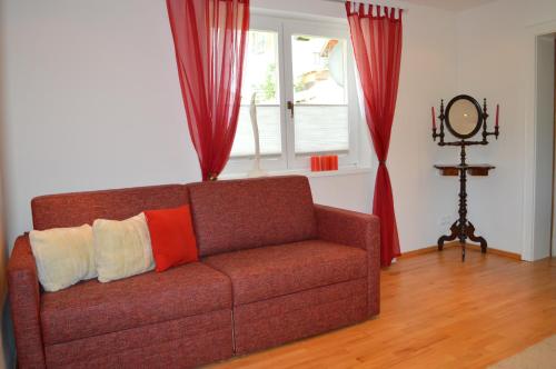 a living room with a brown couch with two pillows at Appartements Strasser Angelika in Westendorf