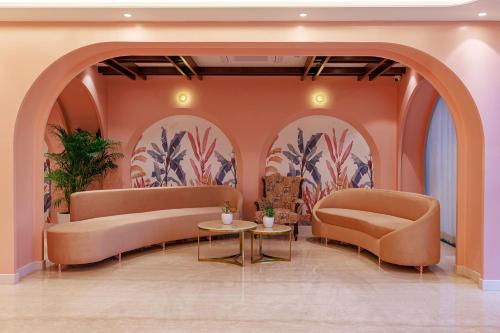 a lobby with two couches and a table at Regenta Place Jaipur Sirsi Road, Jaipur in Jaipur