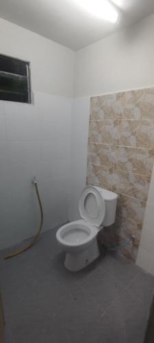 a bathroom with a white toilet in a room at roomstay batu buruk in Kuala Terengganu