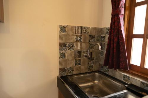 a kitchen with a sink and a window at Vistar Holidays in Goa