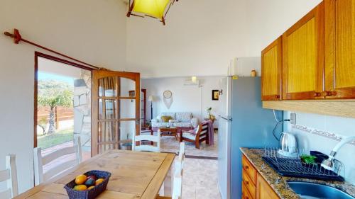 a kitchen with a table and a dining room at Casa chalet , Centro de La Paloma in La Paloma
