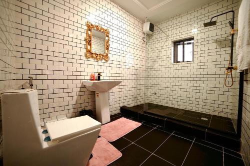 a bathroom with a toilet and a sink at Executive Luxury Room - Sleeps 2 - Pool - Gym in Lagos