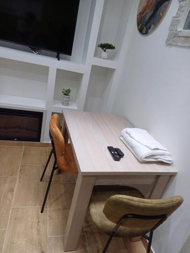 a table and two chairs in a room with a television at B&B Romeo2 in Bari