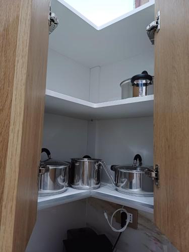 a kitchen with two pots and pans on a shelf at B&B Romeo2 in Bari