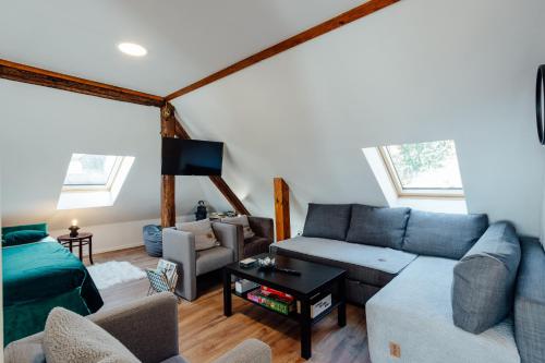 a living room with a couch and a table at Apartmán Franko in Banská Štiavnica