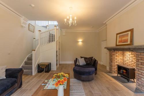 a living room with a couch and a fireplace at Northleigh in Chulmleigh
