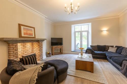 a living room with two couches and a fireplace at Northleigh in Chulmleigh