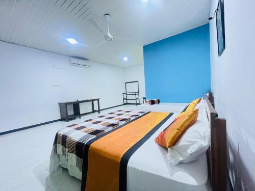 a bedroom with a bed in a room with a blue wall at Tamarind Tamarind Resort, Tourist Board Approved in Habarana