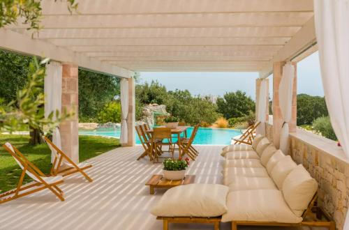 a patio with a couch and a table and chairs at PETRA ANTIQUA in Locorotondo