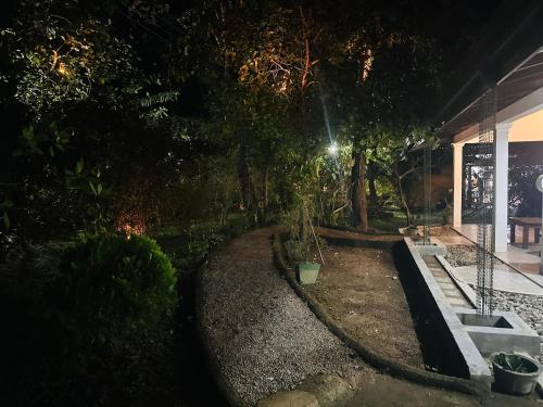 a night view of a garden at night at Tamarind Tamarind Resort, Tourist Board Approved in Habarana