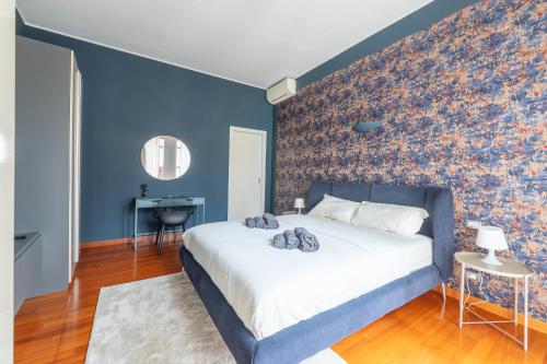 a bedroom with a large bed with a blue wall at La dimora del Marchese in Duomo in Milan