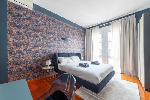 a bedroom with a bed and a wall covered in floral wallpaper at La dimora del Marchese in Duomo in Milan