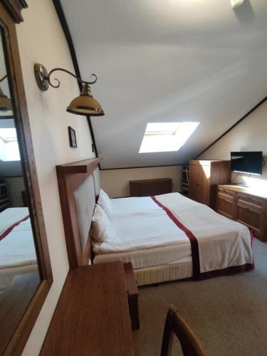 a bedroom with two beds and a mirror at 7 Pools SPA Boutique Hotel in Bansko