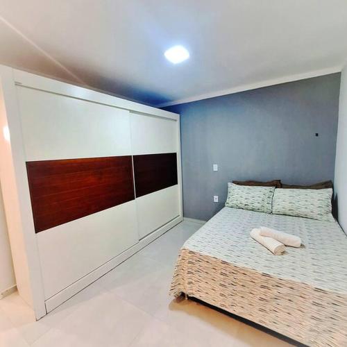a bedroom with a bed with two towels on it at Casa aconchegante no centro de Remanso in Remanso