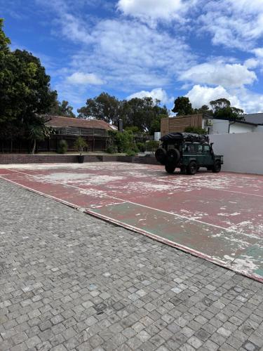 a green truck parked in a parking lot at RElaxed city living in Port Elizabeth