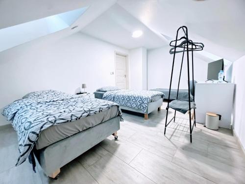 a bedroom with two beds and a chair at Farma IT in Jamielnik