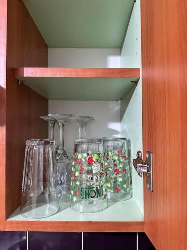 a shelf with two glass items on it at Airrose two bed apartment in Wolverhampton