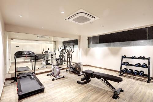 a gym with several exercise equipment in a room at Saltstayz Premier - Golf Course Road & Sector 42 in Gurgaon