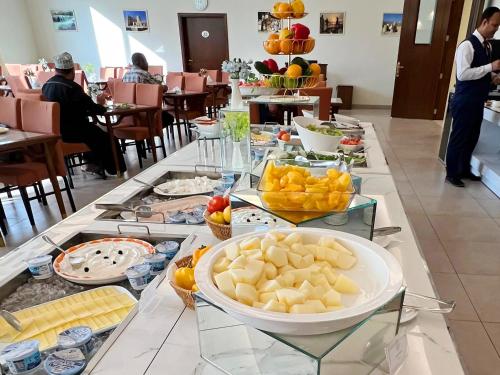 a buffet of food on a table in a restaurant at ROZANA HOTEL in Muscat