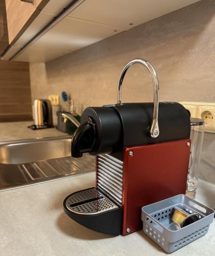 a black and red coffee maker on a kitchen counter at Apartmány Formanka na náměstí in Hustopeče