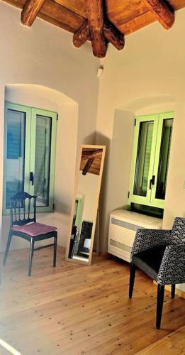 a room with a mirror and a chair and a bed at Vista Del Mar Mansion in Spile