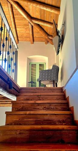 a stairway with a chair sitting on top of it at Vista Del Mar Mansion in Spile