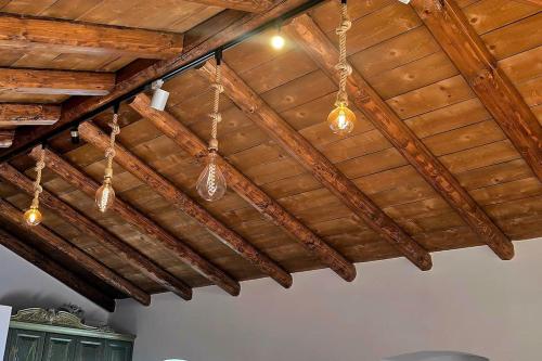 a ceiling with wooden beams and lights in a room at Vista Del Mar Mansion in Spile