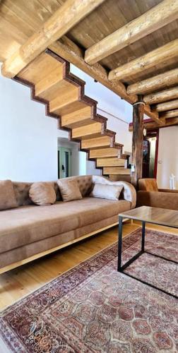 a living room with a couch and a staircase at Vista Del Mar Mansion in Spile