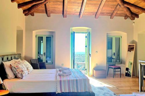 a bedroom with a bed and a view of the ocean at Vista Del Mar Mansion in Spile