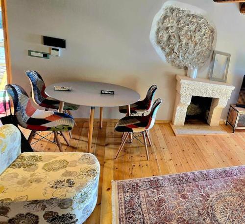a living room with a table and chairs and a fireplace at Vista Del Mar Mansion in Spile