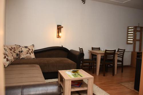 a living room with a couch and a table at Vikendica Čeperković #1 in Kopaonik