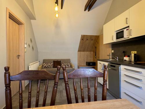 a kitchen with a table and two chairs in a kitchen at Apartmány Formanka na náměstí in Hustopeče