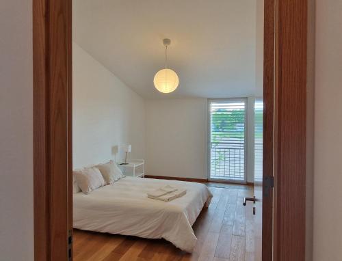 a bedroom with a white bed and a window at Wonderful cozy apartment very well located in Gross Gurmels
