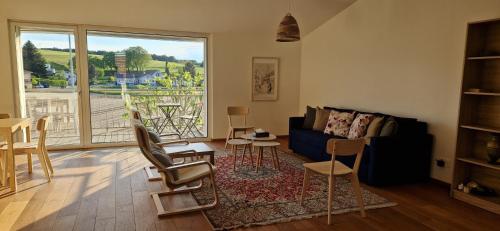 a living room with a couch and a table and chairs at Wonderful cozy apartment very well located in Gross Gurmels