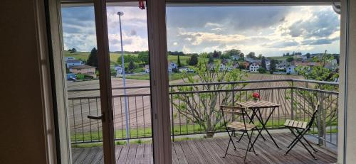 a view of a balcony with a table and chairs at Wonderful cozy apartment very well located in Gross Gurmels