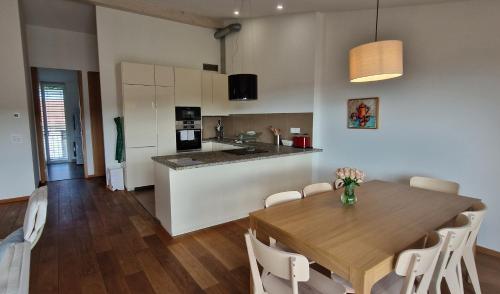 a kitchen and dining room with a wooden table at Wonderful cozy apartment very well located in Gross Gurmels