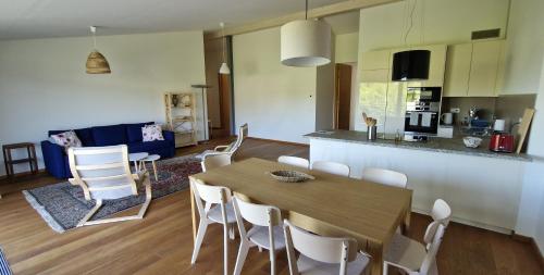 a kitchen and living room with a wooden table and chairs at Wonderful cozy apartment very well located in Gross Gurmels