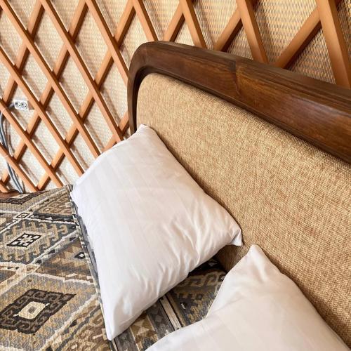 a pillow sitting on a bed in a room at Ethno complex Ala kuch in Kaindy