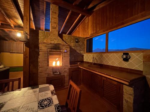 a kitchen with a counter and a table and a window at Casa Tortuga in Tarajalejo