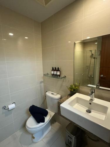 a bathroom with a toilet and a sink at Rustic Elegance New One Bedroom One Uptown Free parking in Manila