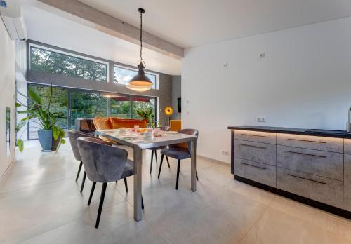 a dining room with a table and some chairs at Hotel am Kurpark in Zinnowitz