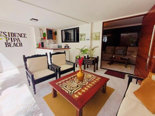 a living room with a couch and a table at Residence Pipa Beach in Pipa