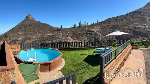 a swimming pool in a yard with a mountain at La Casita de Tila in Ifonche