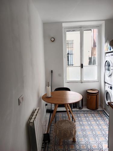 une salle à manger avec une table et une fenêtre dans l'établissement Appartement à 9 min du Palais de L'Élysée, Paris, à Paris