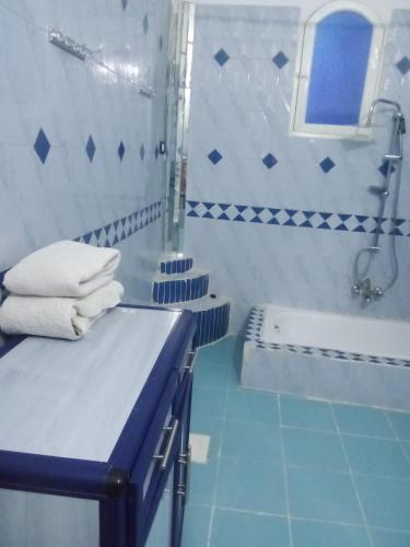 a blue and white bathroom with a sink and a tub at Nubian Life Nile View in Aswan